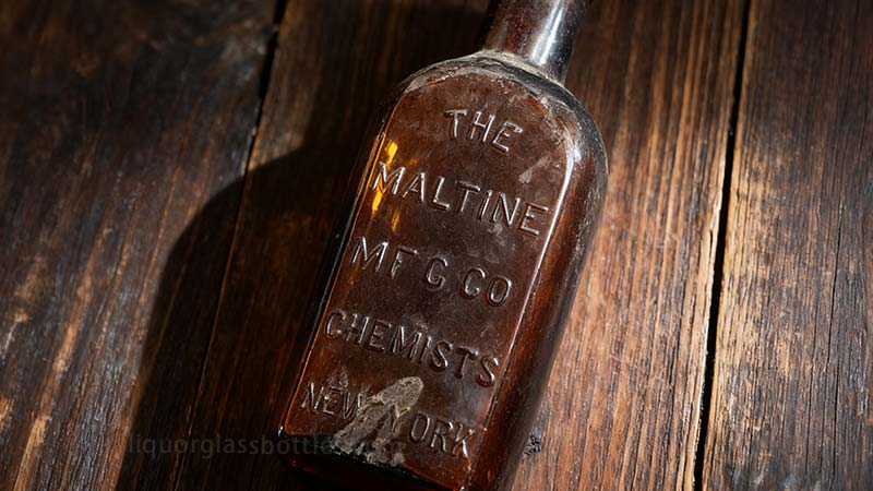 Old Glass Liquor Bottle-embossed text Old Glass Liquor Bottle-embossed text