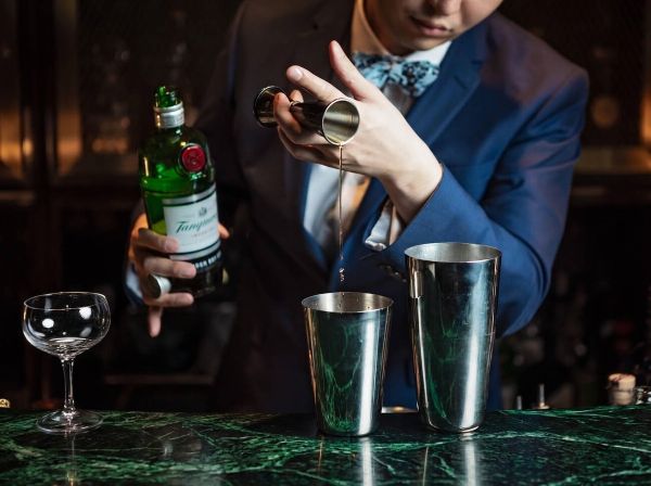 Bartender Spends Holding Gin Bottle