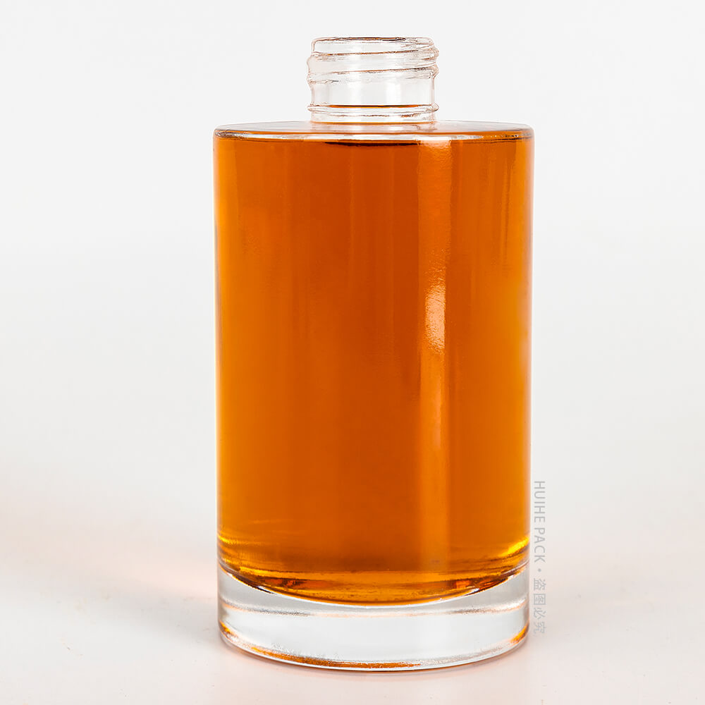 rounded glass liquor bottle