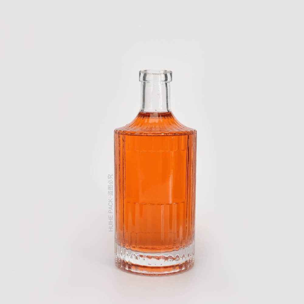 clear glass liquor bottle