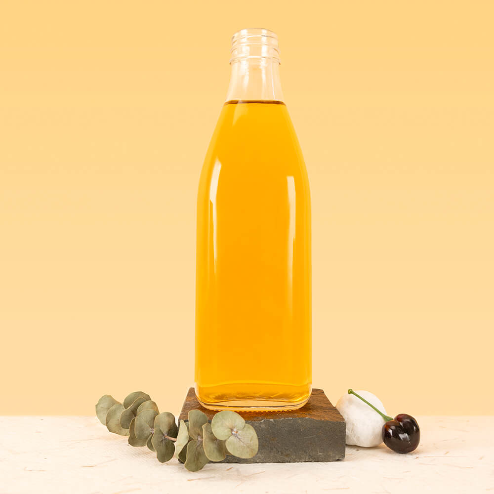 clear glass juice bottle