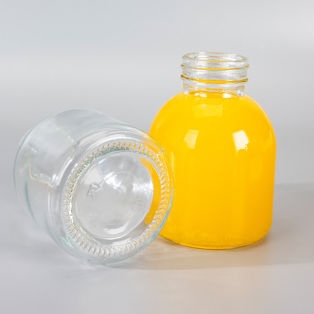 round glass beverage bottle